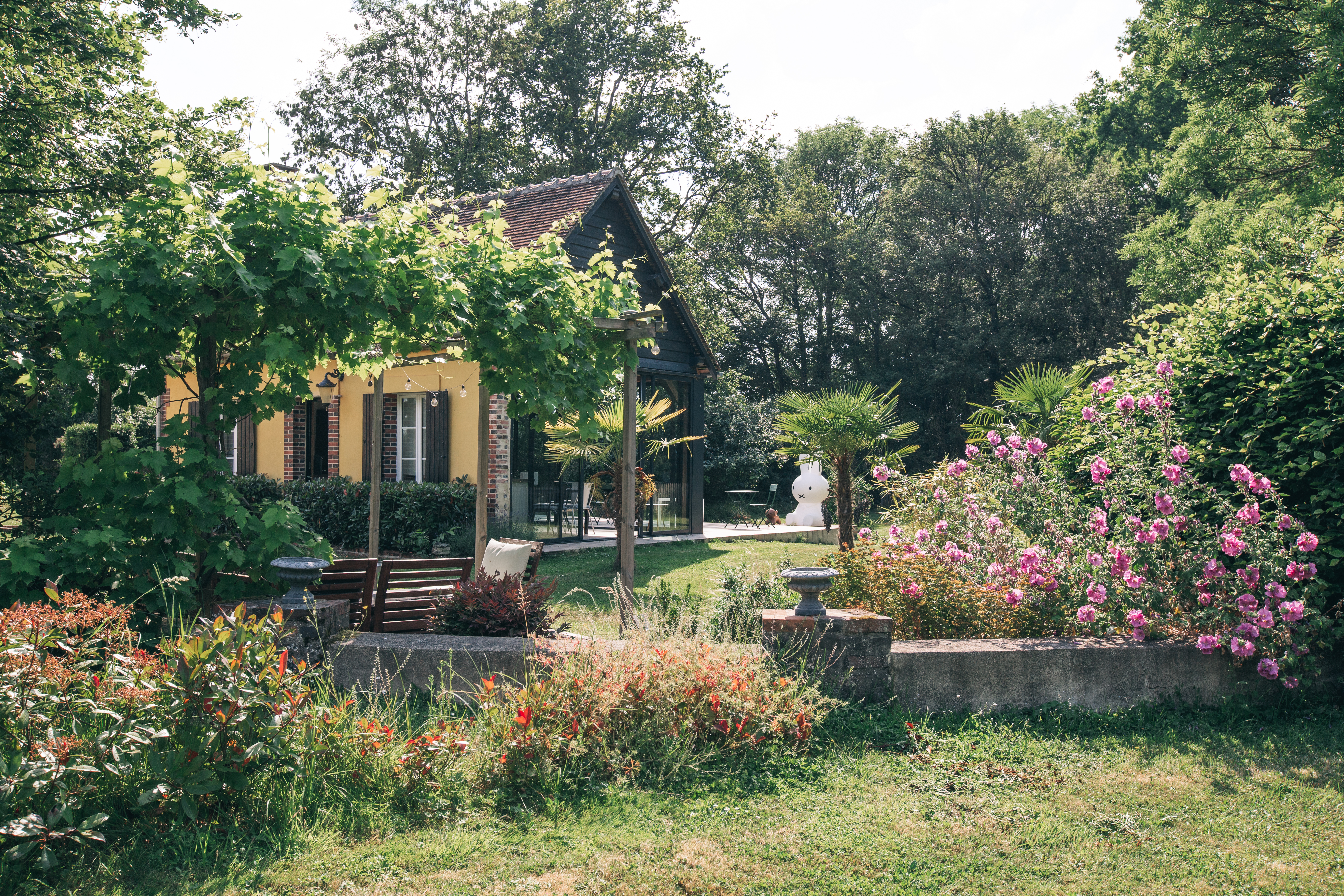 petite maison dans jardin fleuri